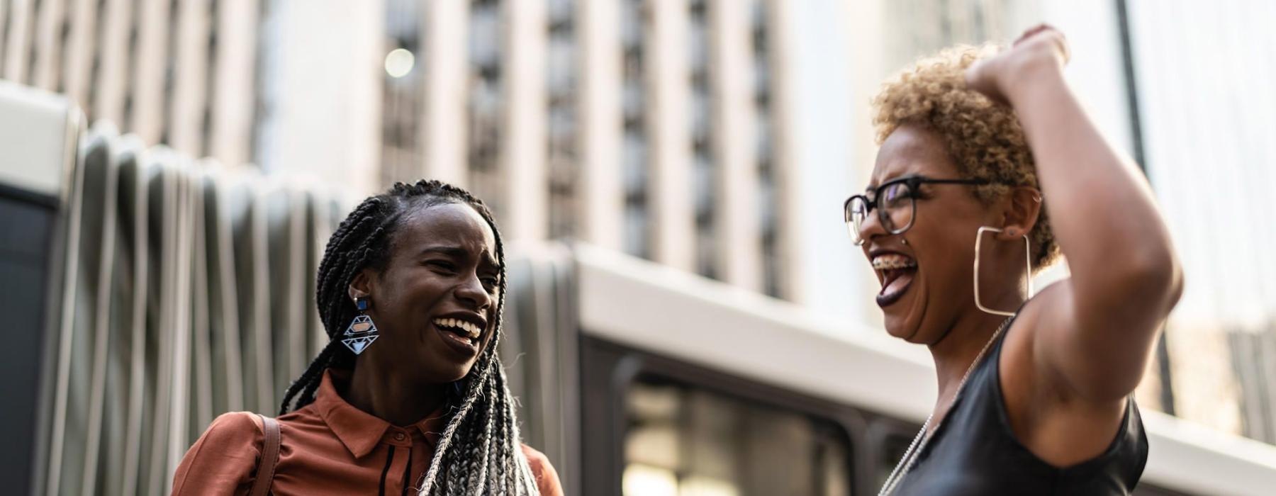 women laughing together in the city