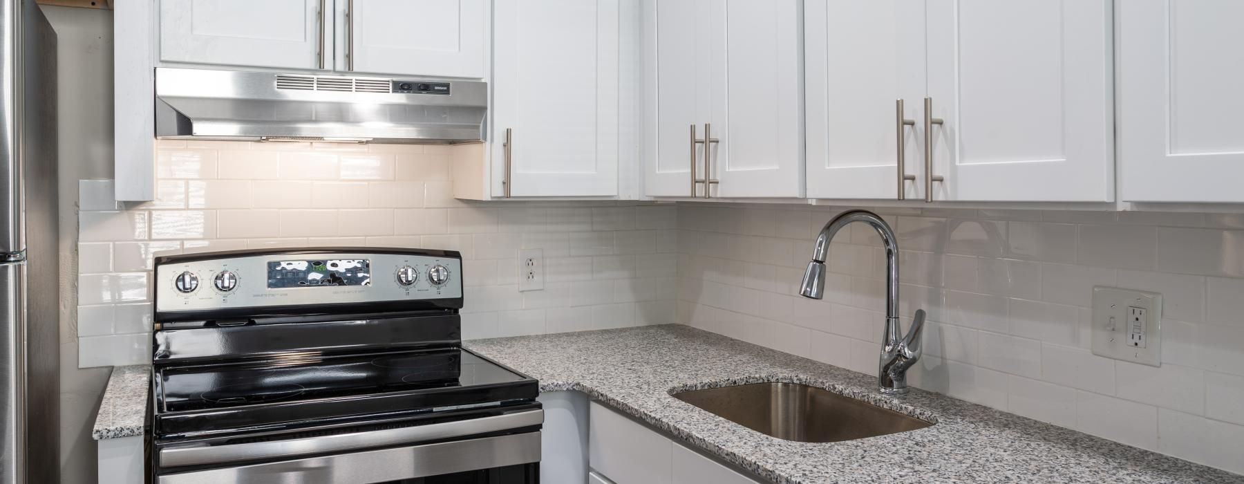 a kitchen with white cabinets